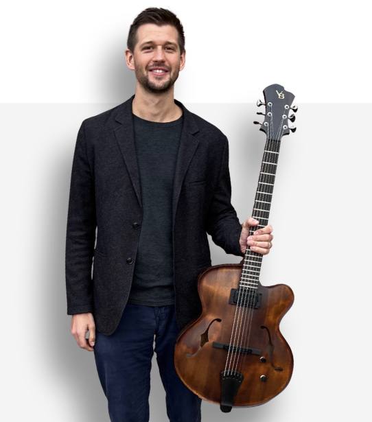 Brent holding guitar